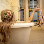 Boho wedding half up half down braided with flowers, beachy curls